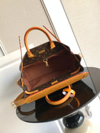 Louis Vuitton monogram handbag with tan leather handles and wide shoulder strap