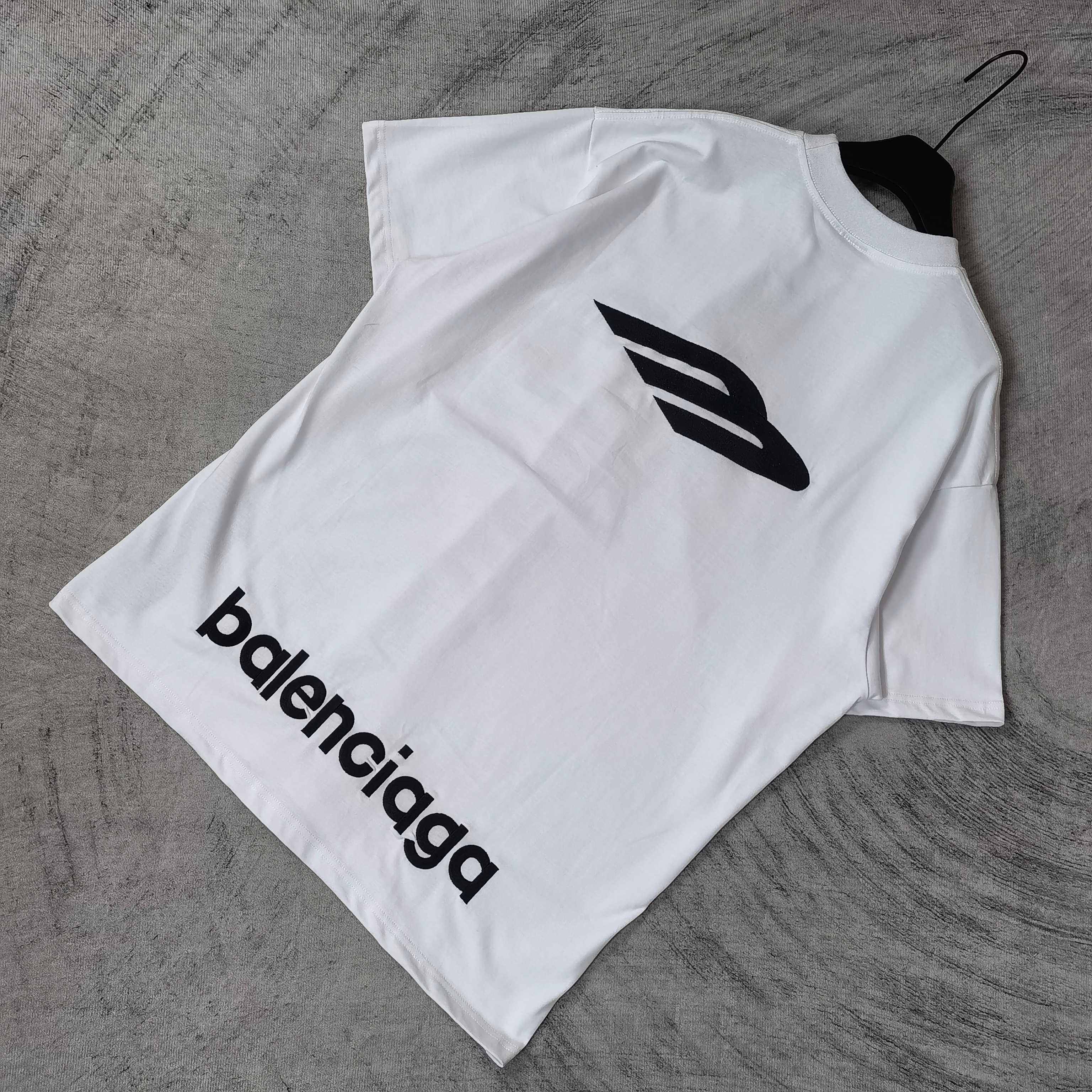 White Balenciaga short-sleeve T-shirt folded flat with large “balenciaga” logo