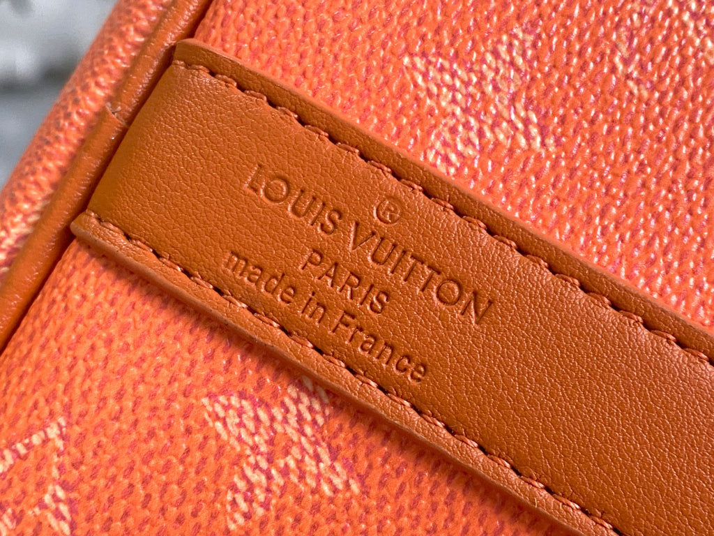 Louis Vuitton leather label patch with “Louis Vuitton Paris” on orange monogram bag