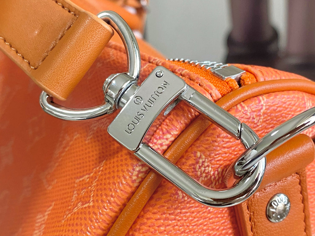 Louis Vuitton orange monogram bag with metal rings and leather crossbody strap
