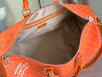 Louis Vuitton orange monogram bag interior view with zip closure and lining.