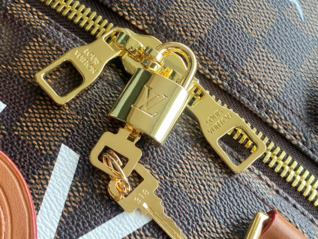 Men's Louis Vuitton zipper pull with gold hardware on textured dark-brown fabric