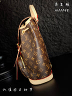 Louis Vuitton monogram canvas mini backpack side view with red strap accents and cream base