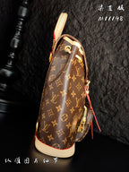 Louis Vuitton monogram canvas mini backpack profile view with red zipper pull and cream trim