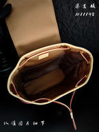 Louis Vuitton monogram mini bag interior view with tan lining and open top
