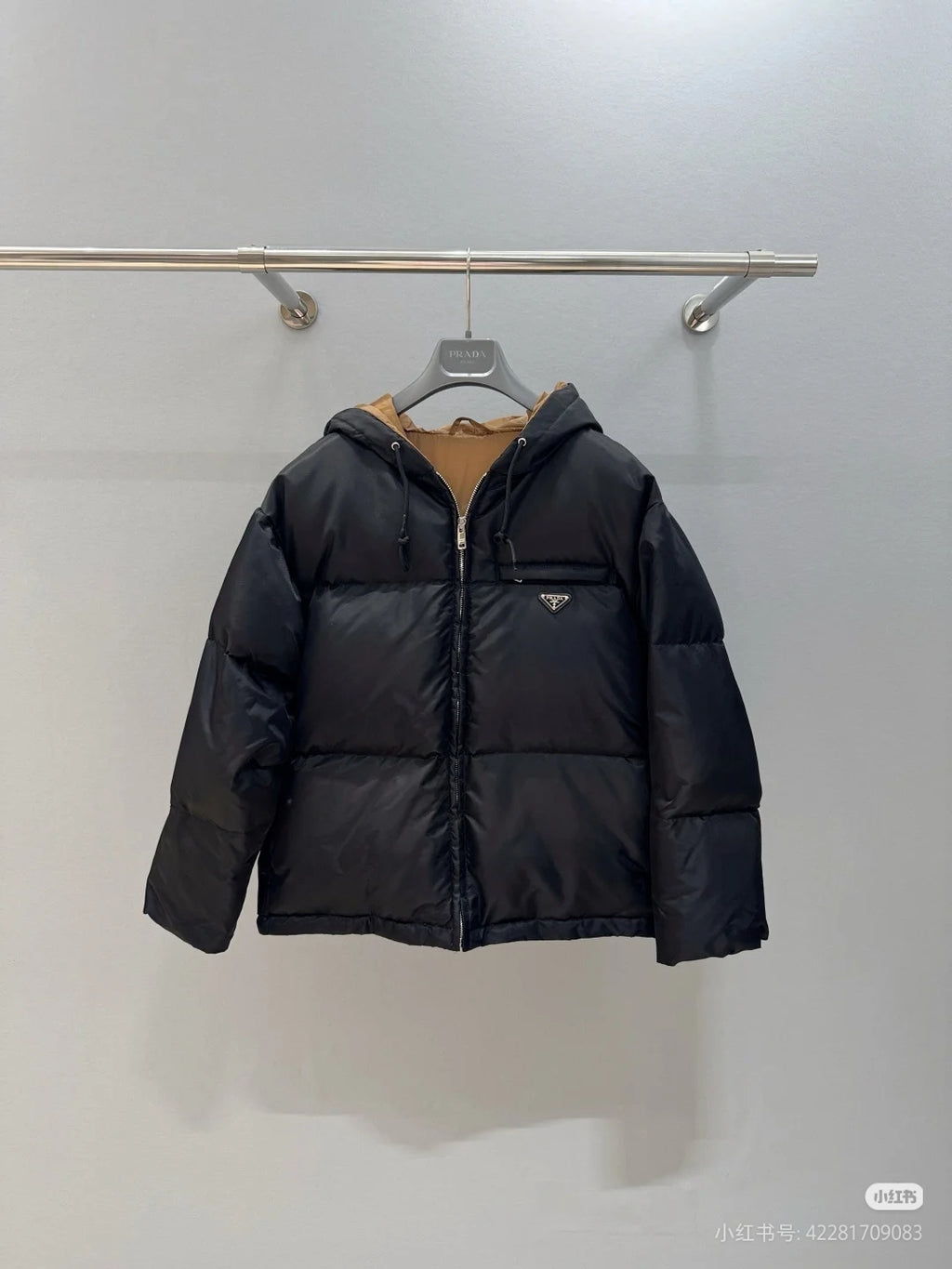Prada hooded puffer jacket, black, full-zip front, front logo patch.