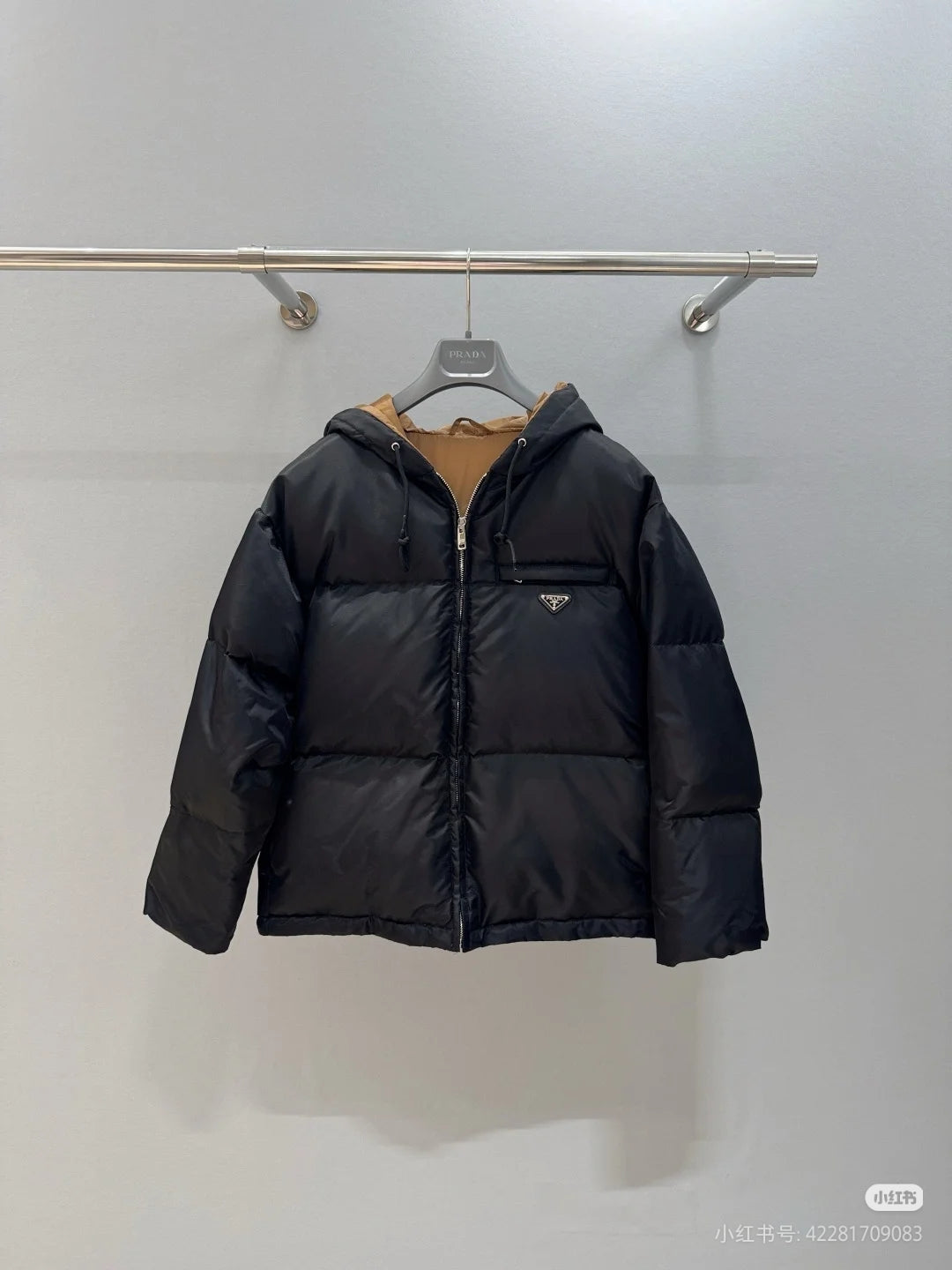 Prada hooded puffer jacket, black, full-zip front, front logo patch.