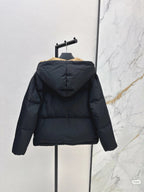 Prada hooded puffer jacket, dark color, back view with full sleeves and hood.