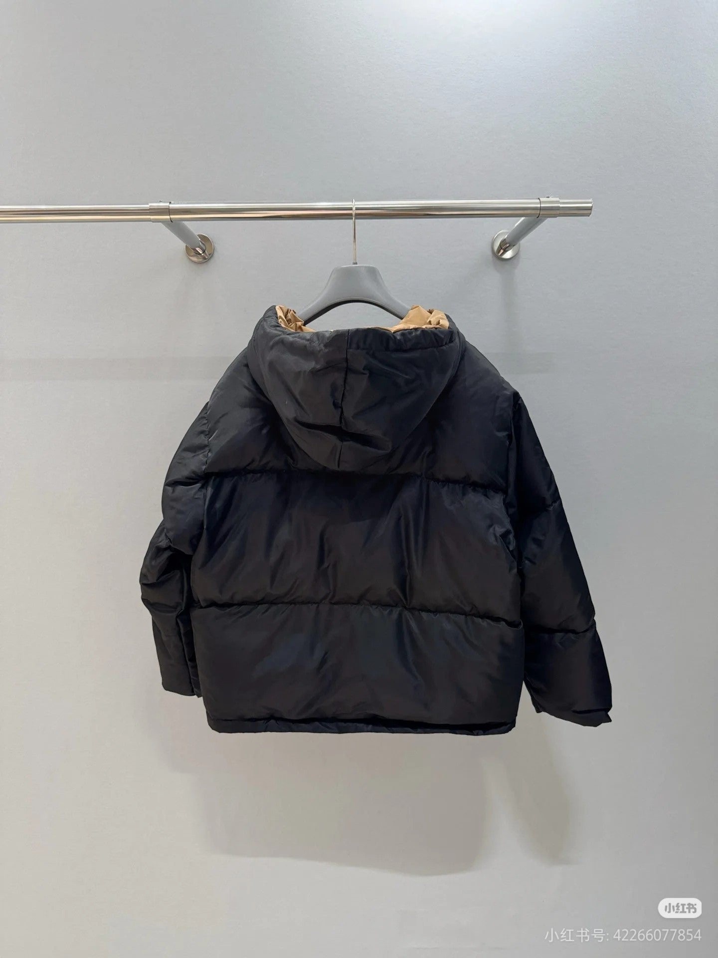 Prada hooded puffer jacket, black, back view with hood and full sleeves.
