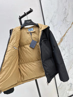 Prada puffer jacket, two-tone black and tan lining, hood and full-zip front visible.