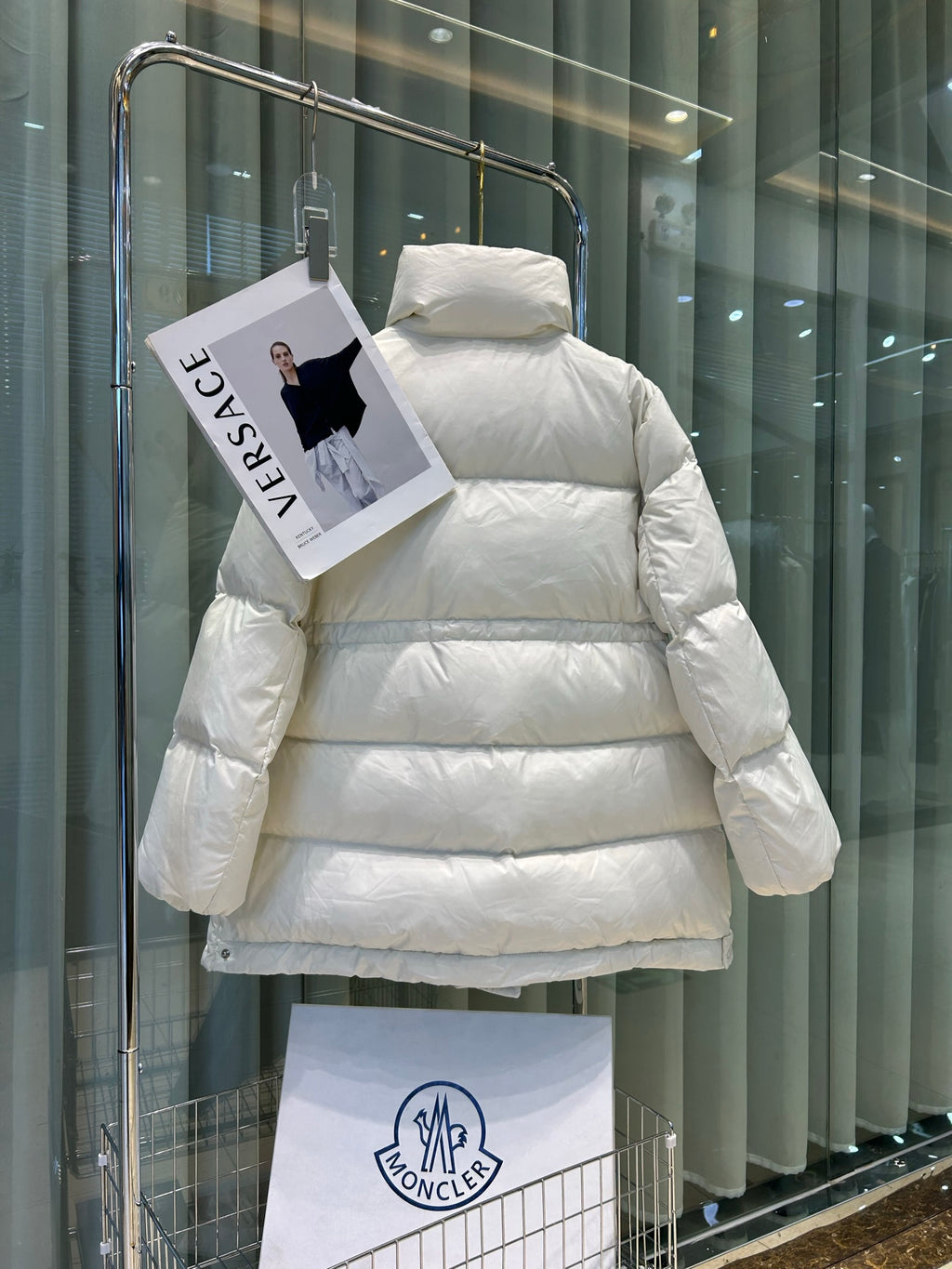 White Moncler puffer jacket, hooded back view, quilted horizontal baffles