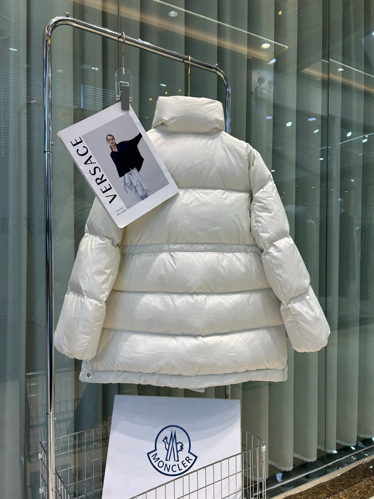 White Moncler puffer jacket, hooded back view, quilted horizontal baffles