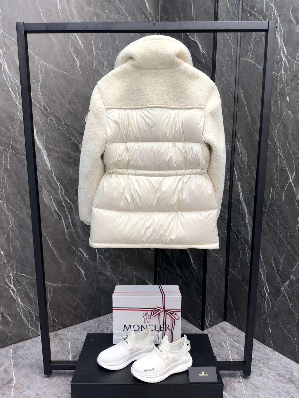 Cream long puffer jacket back view with hood and quilted horizontal baffle panels