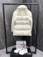Cream long puffer jacket back view with hood and quilted horizontal baffle panels