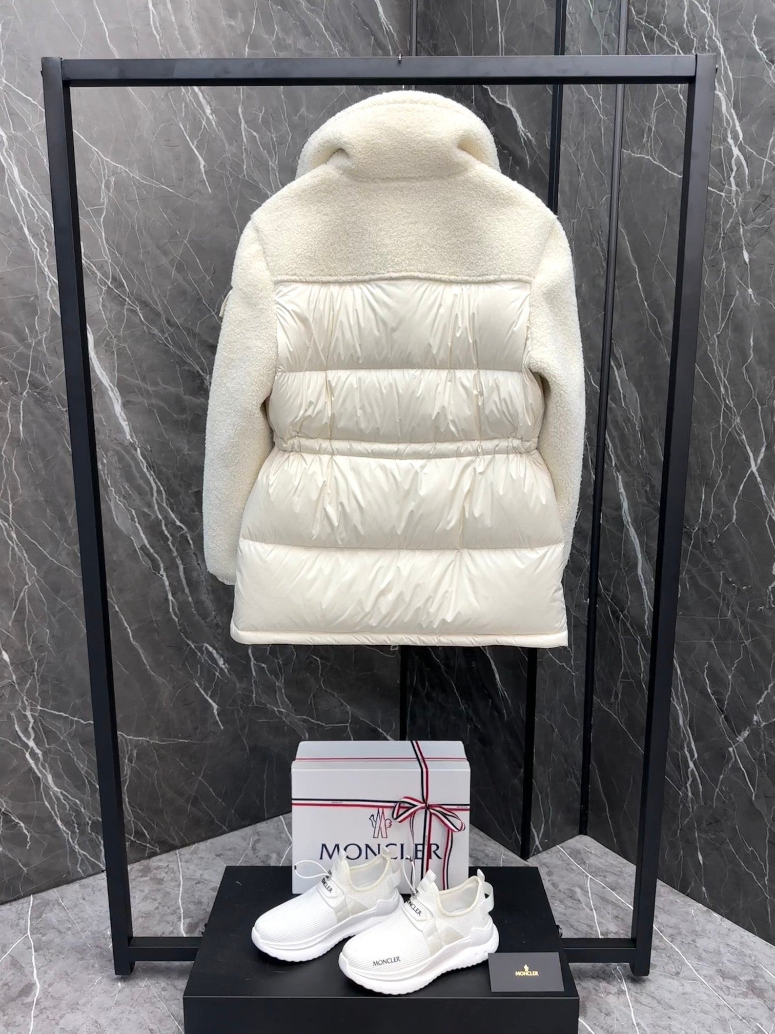 Cream long puffer jacket back view with hood and quilted horizontal baffle panels