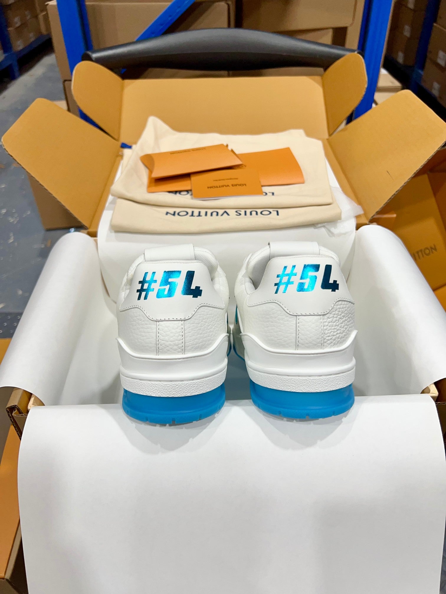 White Louis Vuitton trainer sneakers with blue heel #54 print, pair in box.