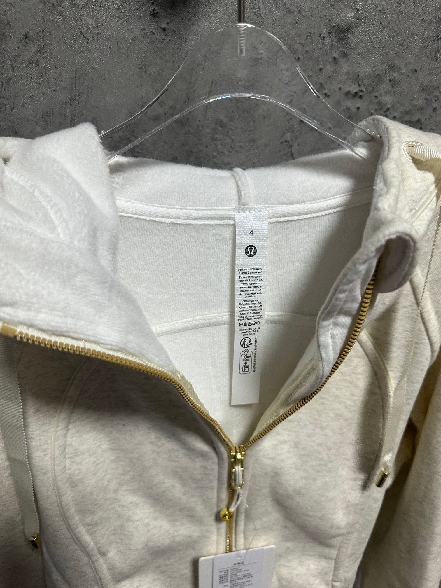 Cream zip-up hoodie inside neckline and front zipper detail