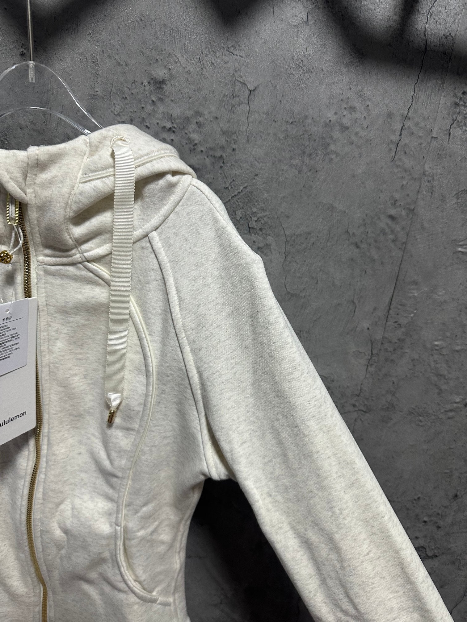 Cream zip-up hoodie with hood and drawstrings detail