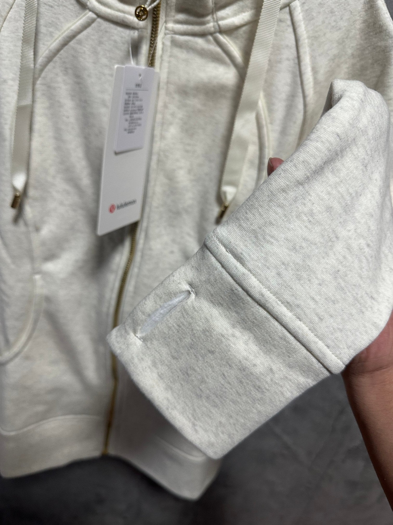 Cream zip-up hoodie sleeve with kangaroo pocket