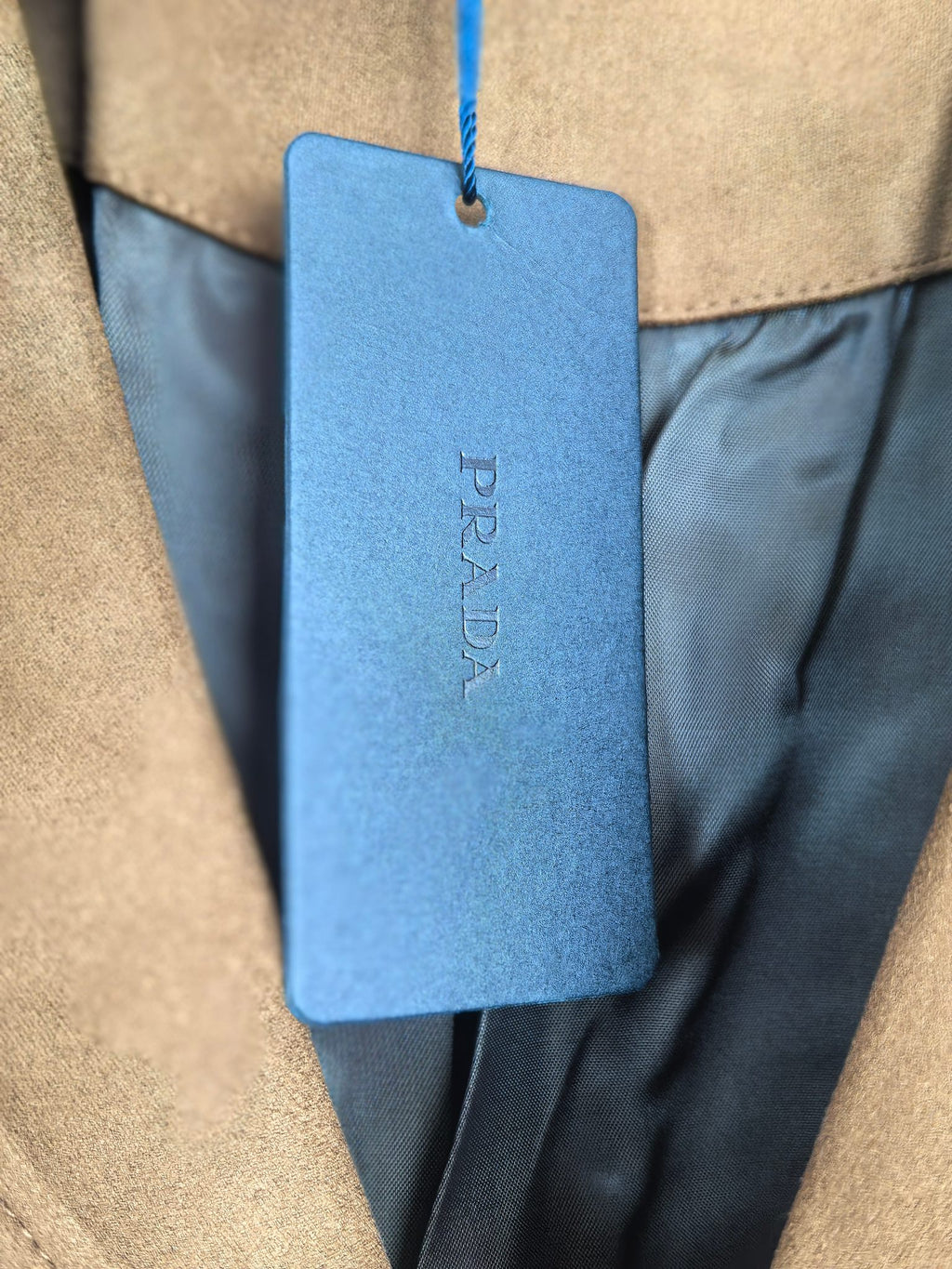 Prada apparel size tag on blue hang tag