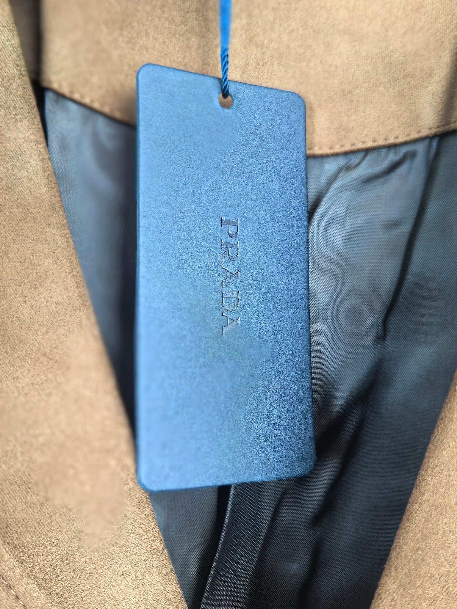 Prada apparel size tag on blue hang tag