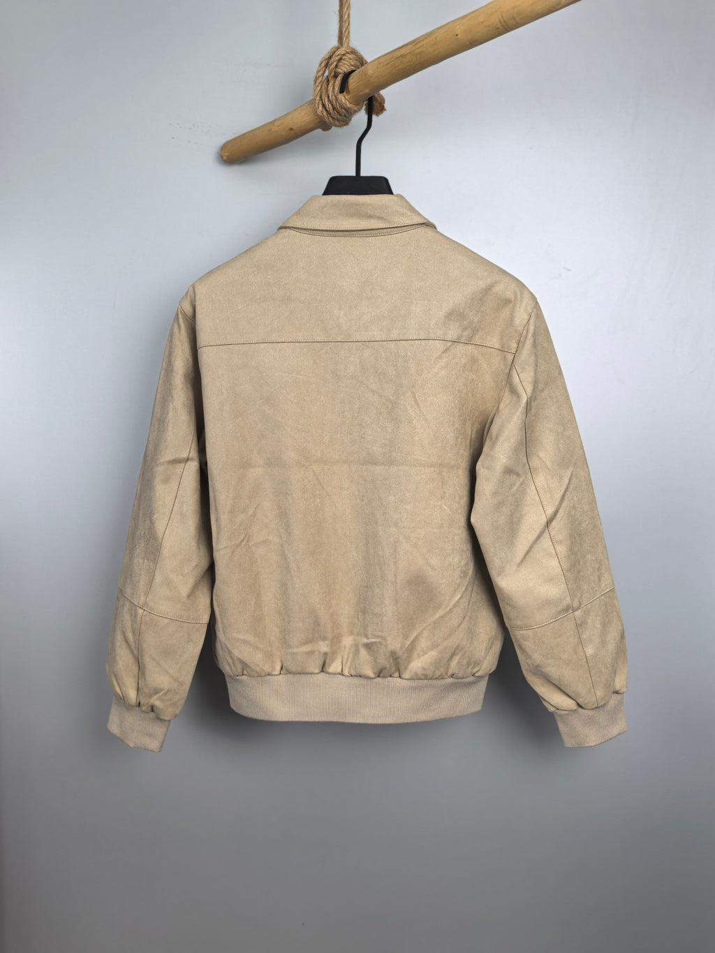 Tan zip-up jacket back view with stand collar and ribbed hem