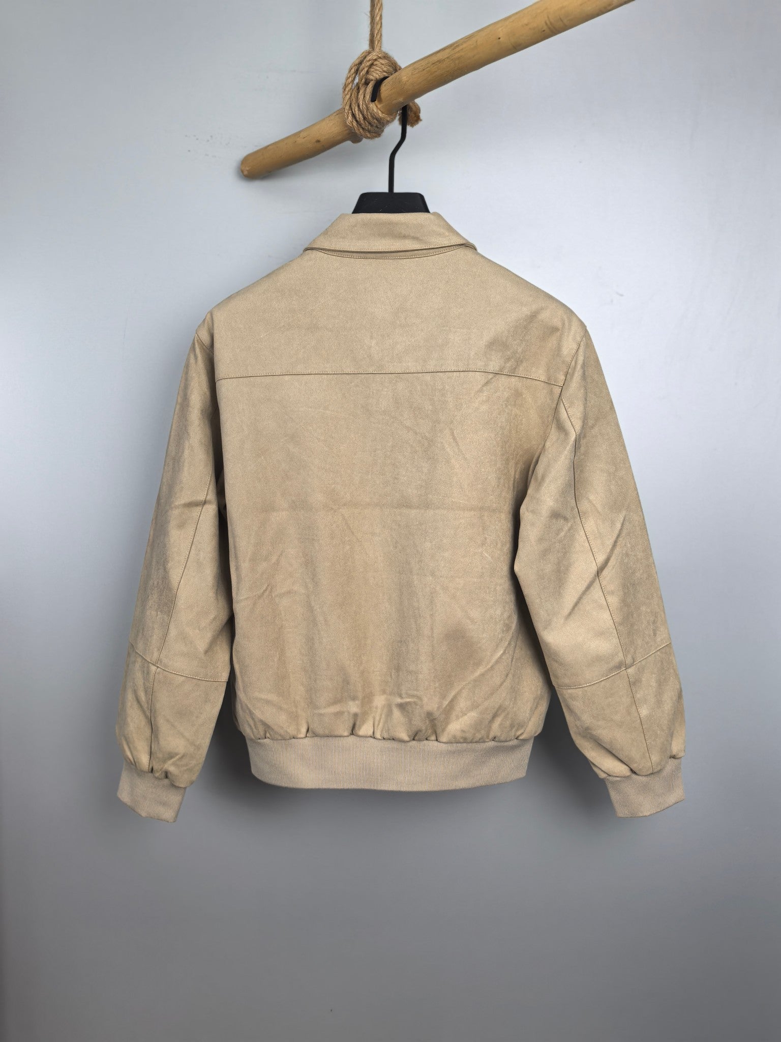 Tan zip-up jacket back view with stand collar and ribbed hem