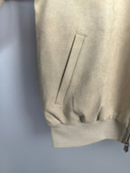 Tan jacket sleeve with vertical seam and ribbed cuff