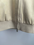Tan jacket with center front zipper and ribbed lower band