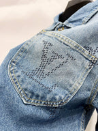 Light blue denim jacket sleeve with monogram design and contrast-stitched seams