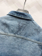 Light blue denim jacket back yoke with monogram pattern and topstitched seam