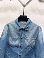 Light blue denim jacket with monogram chest panels, pointed collar and gold buttons
