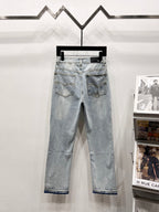 Light blue wash denim jeans with front pockets and rhinestone side embellishments
