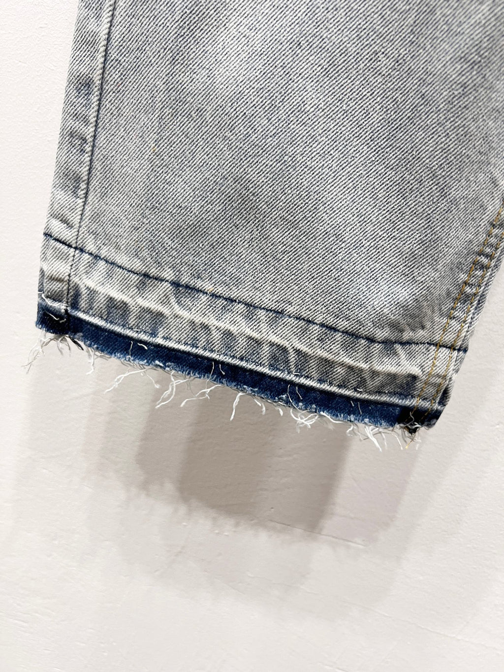Light blue denim jeans with frayed cuff hem and stitched hem detail