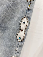 Light blue denim jeans with colorful beaded charm trim along side seam