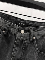 Black denim jeans waistband with AMIRI logo patch and button closure
