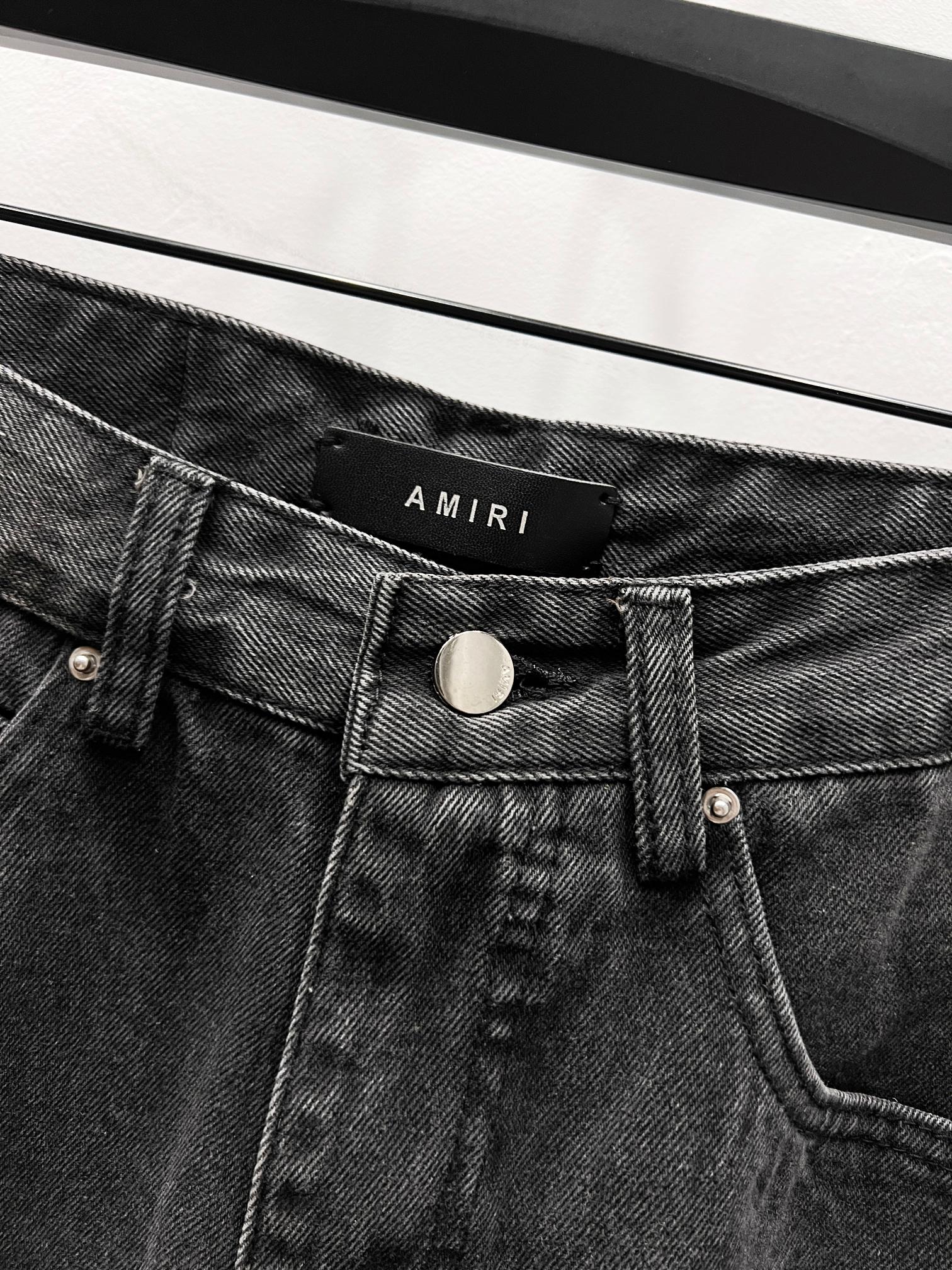 Black denim jeans waistband with AMIRI logo patch and button closure