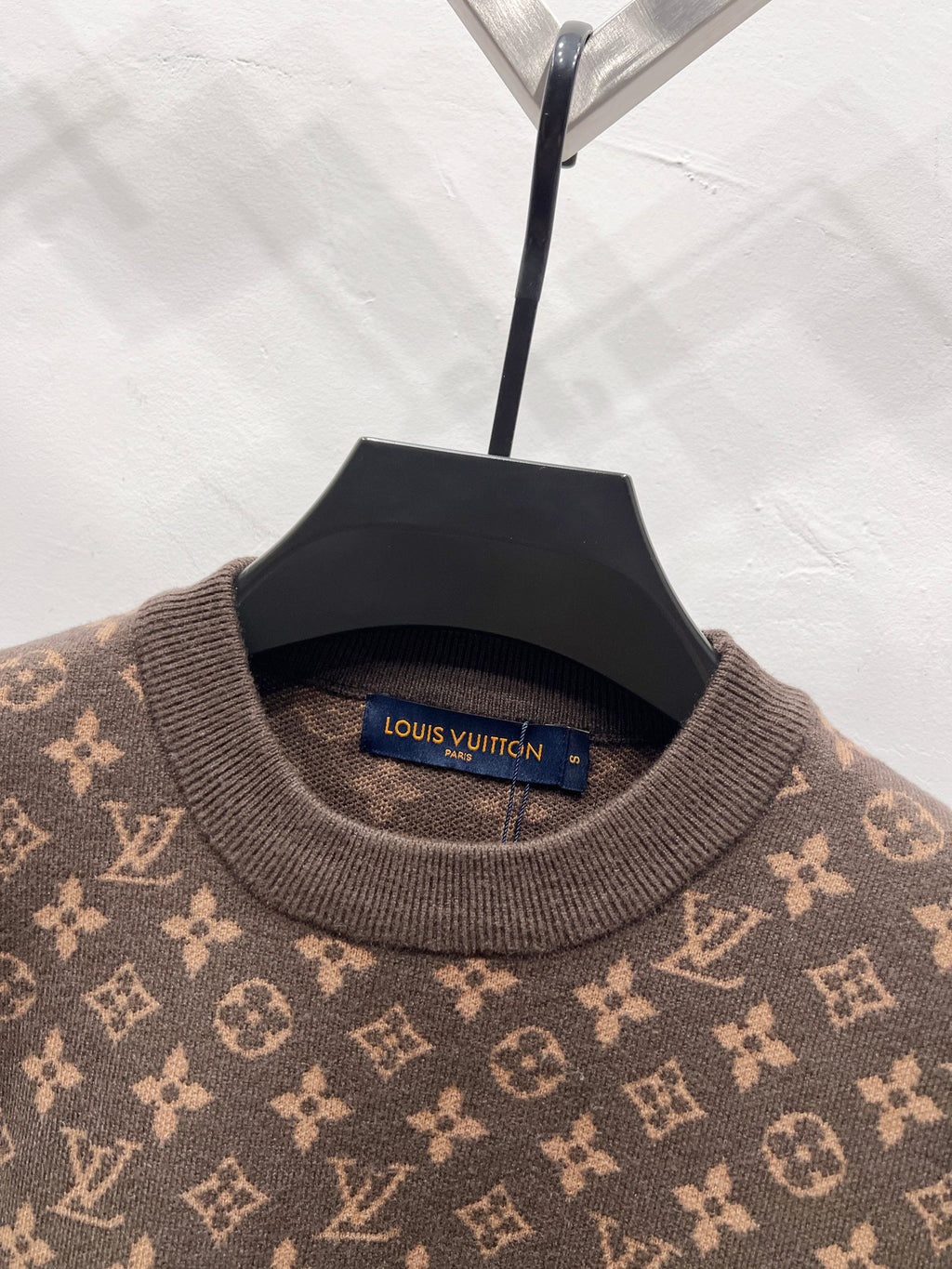 Crewneck sweater neck with visible Louis Vuitton logo tag and monogram knit