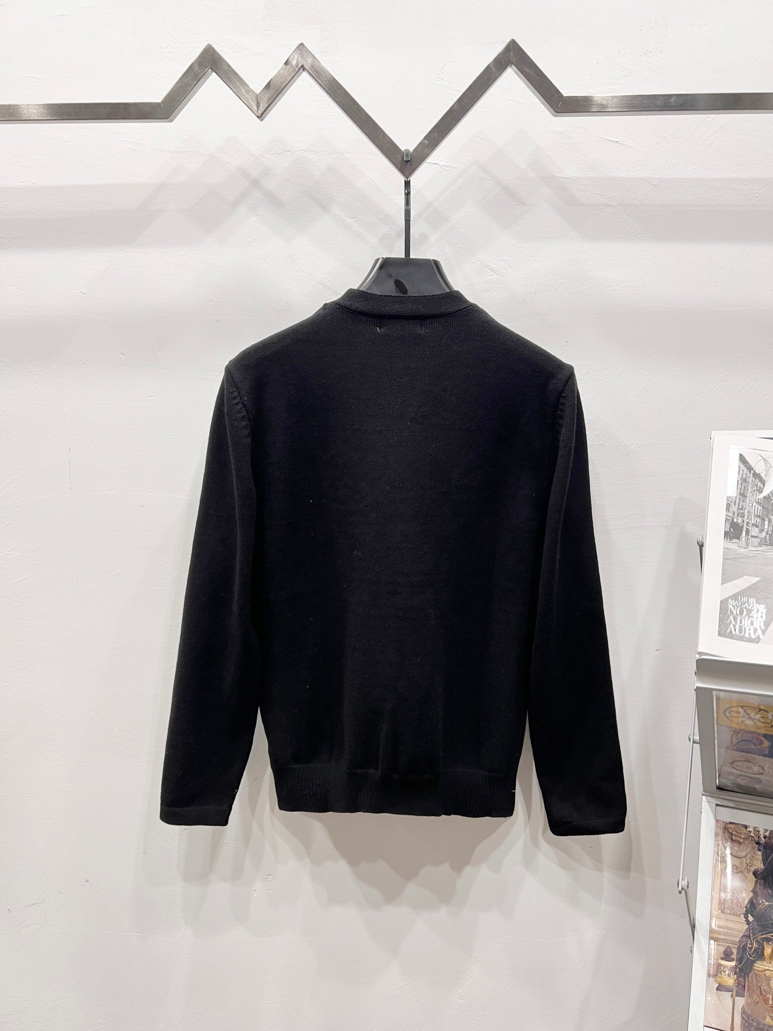 Black crewneck sweater with long sleeves, back view