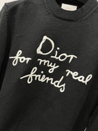 Black knit sweater with large “for my real friends” script print