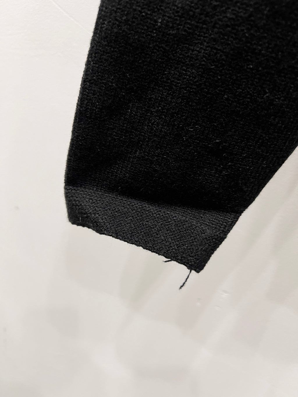 Black sweater sleeve cuff close-up
