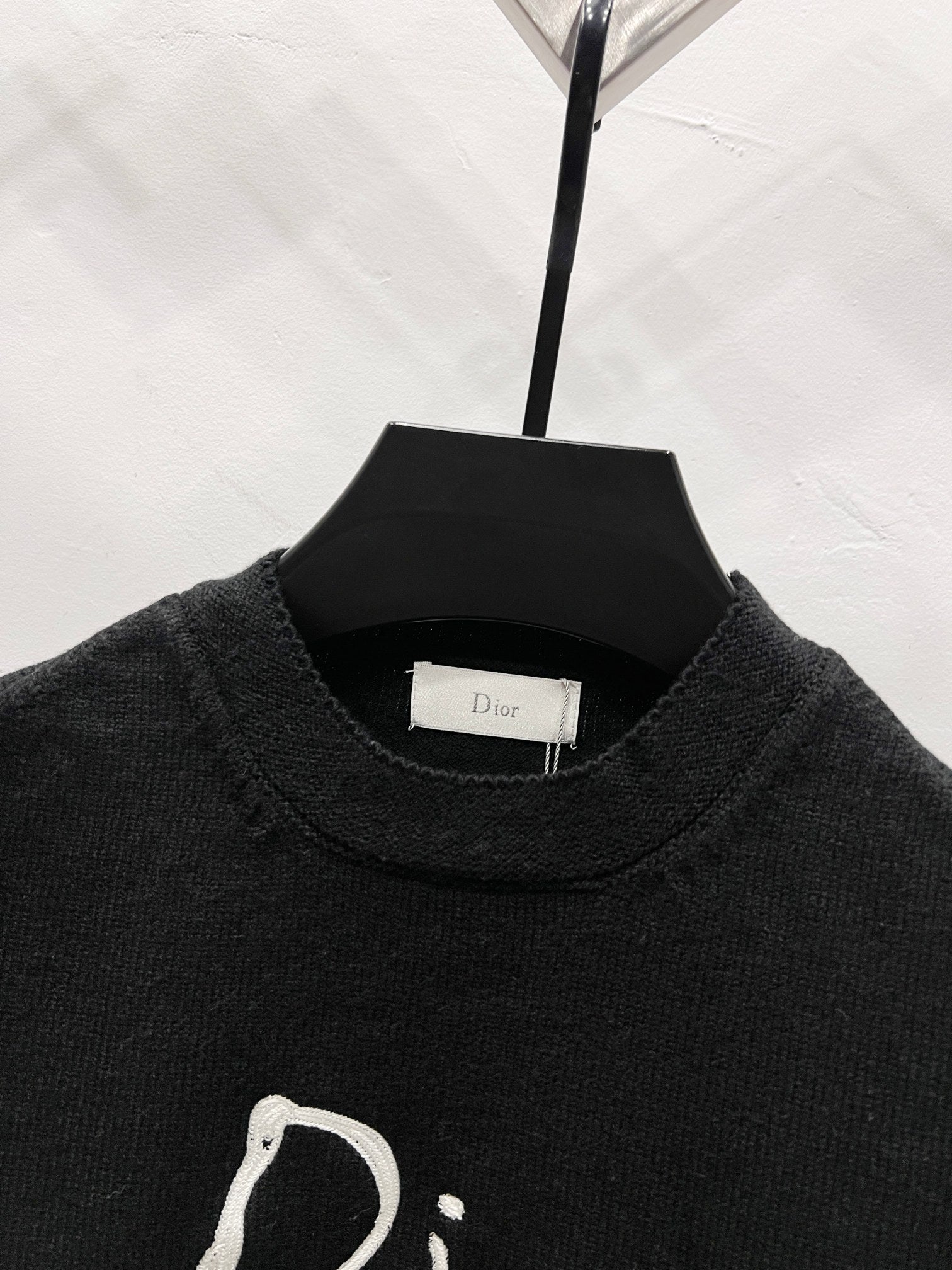 Black crewneck sweater close-up of neckline and knit texture