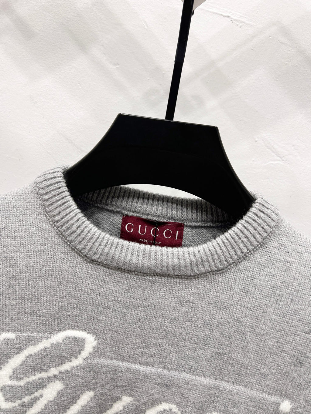 Gray sweater neckline with ribbed knit and Gucci label inside