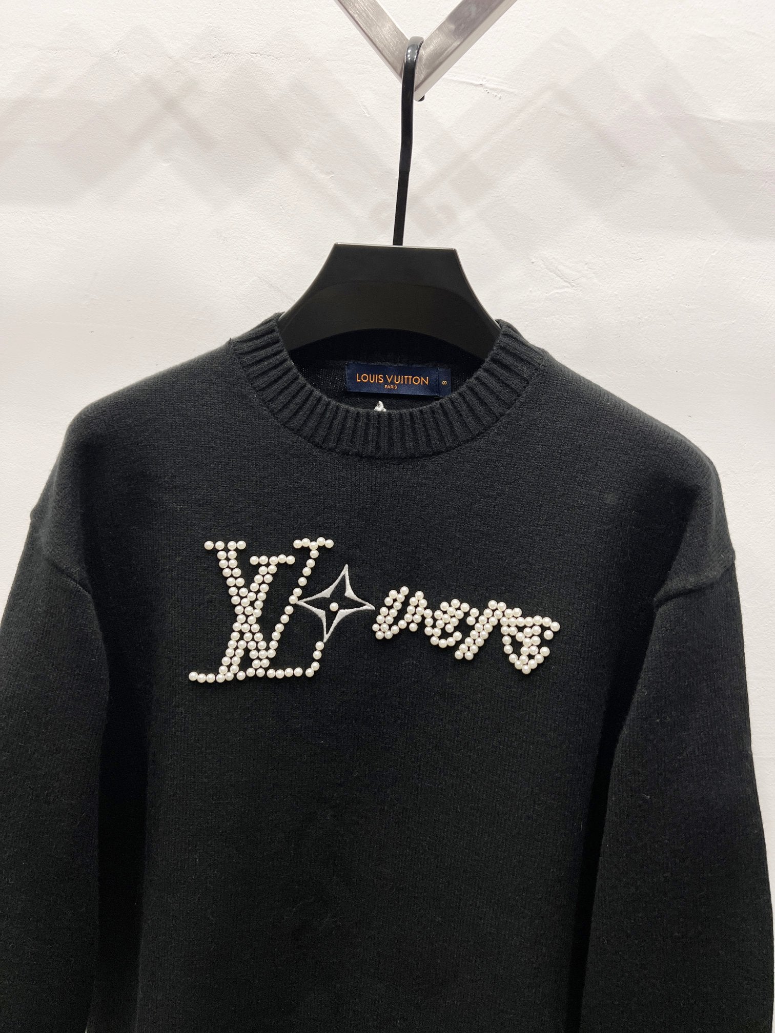 Louis Vuitton black sweater with rhinestone LV logo across the chest