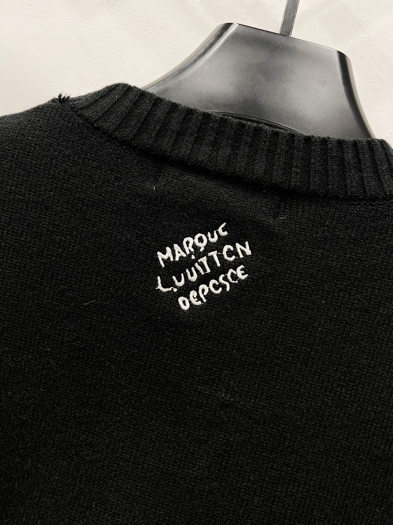 Louis Vuitton black knit collar detail with small embroidered text
