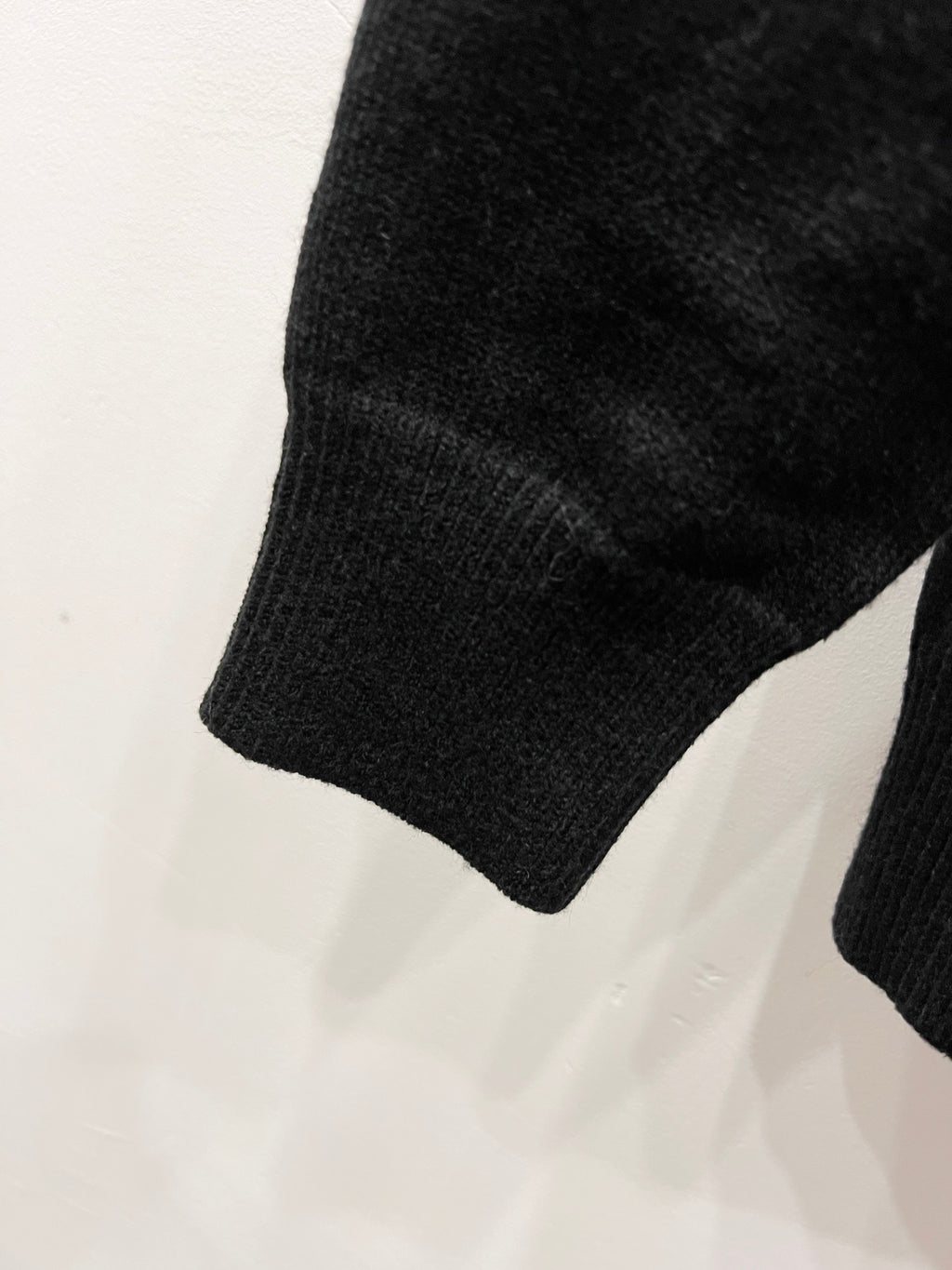 Black knit sweater sleeve with ribbed cuff