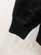 Black knit sweater sleeve with ribbed cuff