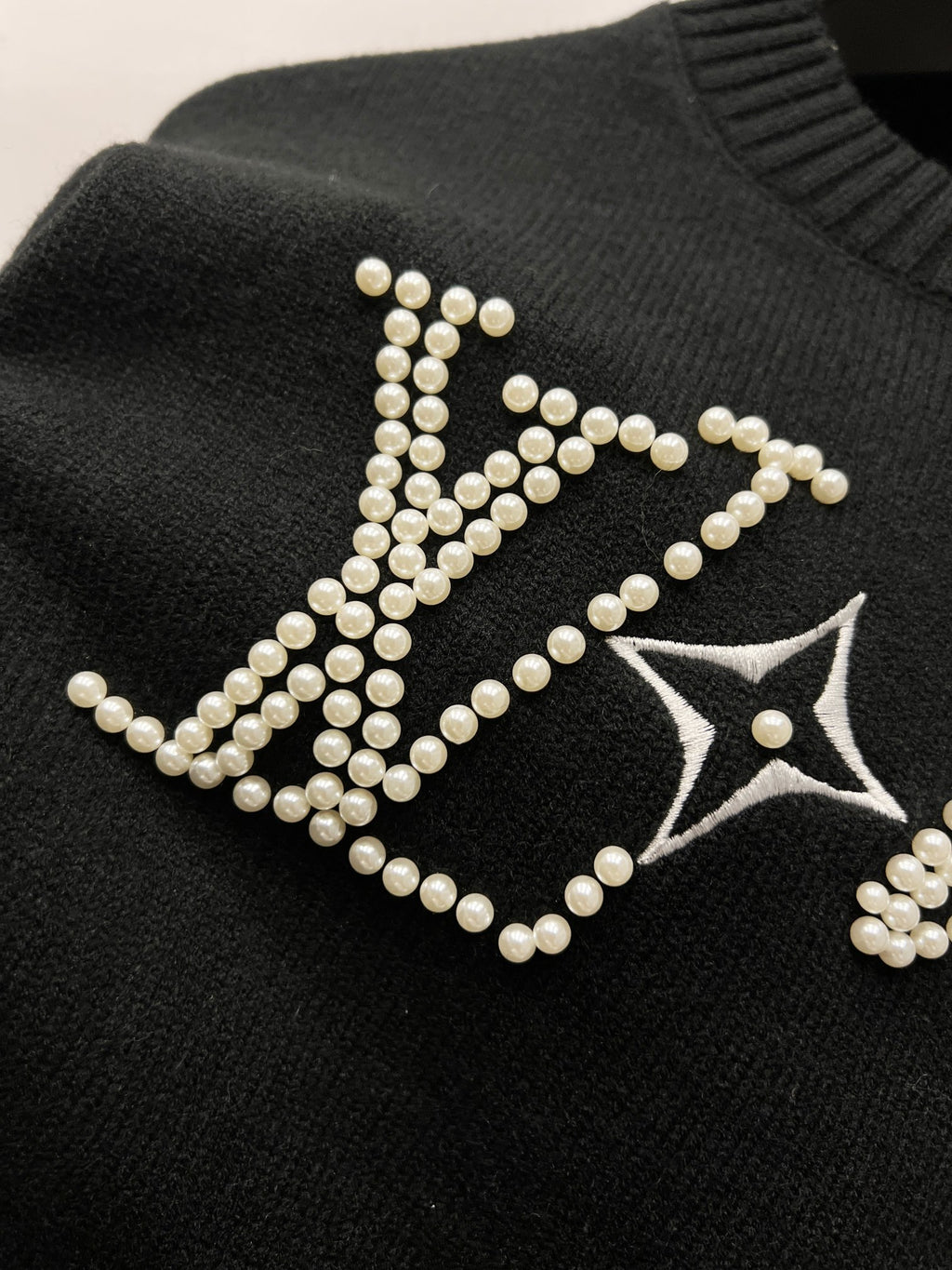 Louis Vuitton black knit sweater with rhinestone LV logo and star detail