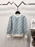 Dior logo knit sweater with crew neck, blue pattern and white ribbed hem