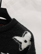 Louis Vuitton sweater sleeve, dark knit with white monogram flower motif